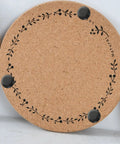 Cork pad with floral design and black non-slip feet, similar to Non Slip Rubber Leg Caps Eight Pack Thickened Design Furniture Pads.