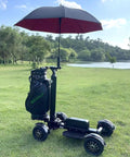 Foldable Electric Golf Push Cart With Cushioned Seat And Sturdy Umbrella Pole on grass beside a pond.