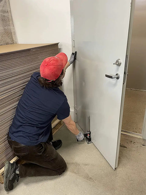 Person uses Heavy Duty Hand Jack Lift Tool For Cabinets, Flooring, Windows And More on a door for alignment and installation support.