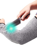 Person wearing Heavy Duty Cut Resistant Arm Sleeves With Thumb Hole 18 Inch Anti Abrasion Safety Arm Guard For Garden And Kitchen Bite Proof Protection For Thin Skin EN388 Level 5 1 Pair while holding knife.
