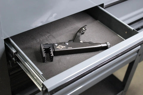 90-Degree Locking Grip Hose Clamp Pliers resting in a tool drawer, black finish, designed for secure clamp removal in auto and aviation work.