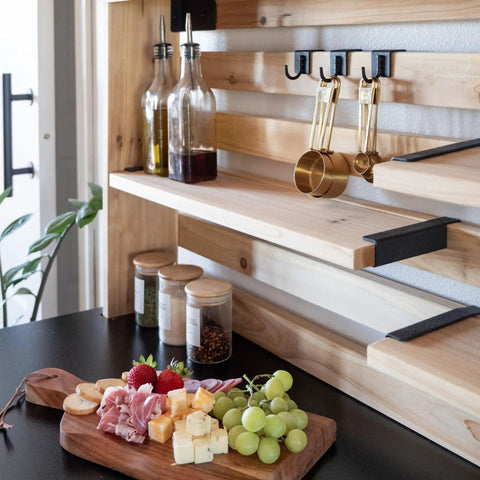 Close-up of cedar wood shelves and black hooks from 48 Inch Cedar Wood Buffet Hutch Serving Station With Galvanized Steel Countertop