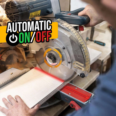 Miter saw with laser guide attached, blue-gray portable saw cutting wood on a red stand