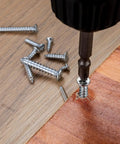 Drill setting 345 Piece 304 Stainless Self Tapping Screws Set For Wood And Metal M3 And M4 into wood surface.