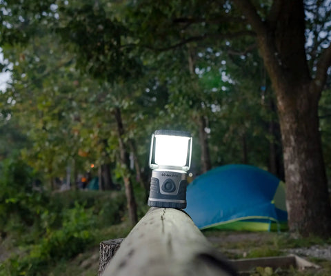 60 Day Portable LED Lantern With 1200 Lumen Power illuminating a campsite at dusk, showing lifetime LED bulbs and built-in hook.