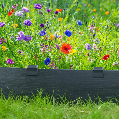 Garden with colorful flowers backed by a black terrace board using 30 Pack 10 Inch Garden Landscape Stakes For Lawn Edging Terrace Board Edging Coil Grass Barrier And Bender Board Heavy Duty Plastic Anchors For Quick Install Durable Garden Liner Support.
