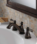 Oil-rubbed bathroom faucet with dual handles on white sink, set against a tiled wall.