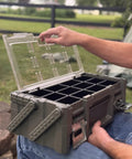 Man opening Olive Green Cantilever Tool Box Organizer With 18 Removable Bins, heavy duty metal latches, clear lid visible