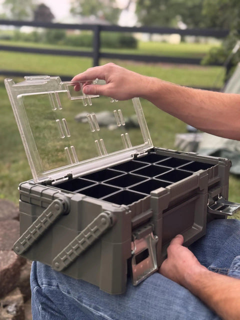 Man opening Olive Green Cantilever Tool Box Organizer With 18 Removable Bins, heavy duty metal latches, clear lid visible