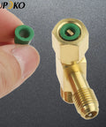 Brass quick-coupler access tee with swivel connector and 1/4 inch male thread; green plastic valve core shown separately.