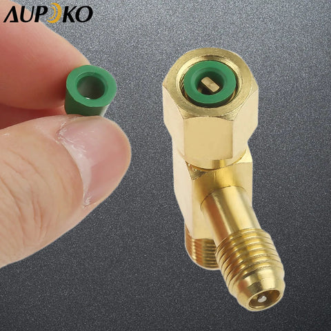 Brass quick-coupler access tee with swivel connector and 1/4 inch male thread; green plastic valve core shown separately.