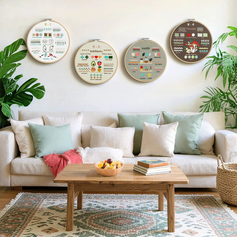 Beginner Embroidery Kit With 4 Learning Stages And 38 Stitches displayed on living room wall over sofa.
