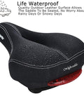 C99 Memory Foam Bike Seat Saddle With Taillight Waterproof Wide Leather Cushion shown with water droplets on surface