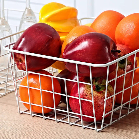 Set Of 4 White Wire Storage Baskets For Freezer, Pantry, And Bathroom Organization filled with assorted fruits