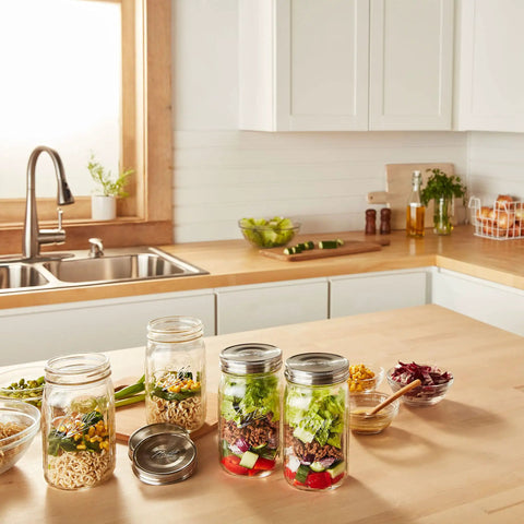 Stainless Steel One Piece Mason Jar Lids Wide Mouth 6 Pack Airtight Seal Rust Resistant Stackable on jars with salads in kitchen