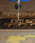 SpeTool tapered ball nose end mill, 1/4 inch shank, 1/64 inch radius, ZrN coated, installed above carved wood letters.