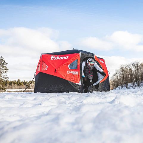 Heavy Duty Pop Up Insulated Ice Fishing Shelter With Knockout Spacious Fishin Spot For Five To Seven Crews, setup in snow.