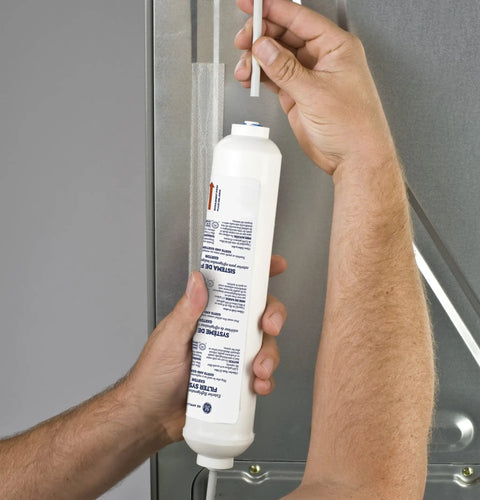 Hands installing Exterior Refrigerator Icemaker Filtration System Inline Water Filter For Better Tasting Ice And Water No-Fuss Install