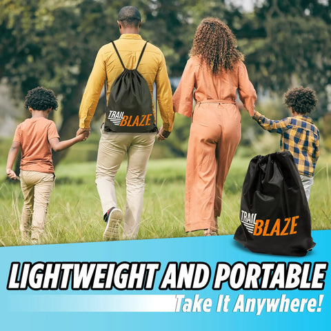 Family carrying TrailBlaze bag with 60ft Backyard Slackline Kit With Wide Tree Protectors For Kids And Adults outdoors