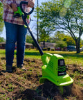 Person using 20V Cordless Garden Tiller Cultivator With 7.5 Inch Tilling Head, 2Ah Battery And Fast Charger Included, Green