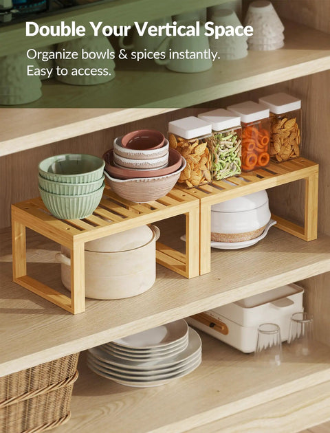Heavy Duty Bamboo Cabinet Organizer Shelf Two Pack Stackable Kitchen Counter Rack Featuring Slatted Draining Surface To Air Out Dishes And Keep Counters Squeaky Clean with bowls and jars stacked.