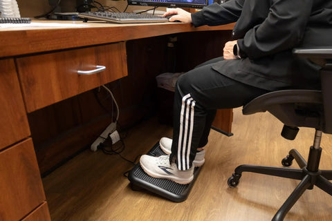 Person using Toasty Toes Foot Warmer And Ergonomic Heated Footrest With Three Adjustable Positions And Two Heat Settings Portable