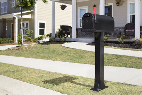 Heavy Duty Post Mounted Outdoor Mailbox in Black with Galvanized Steel Construction on curb, in front of a home