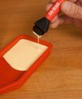 Applying glue with Non Stick Wood Glue Brush Silicone Applicator Kit With Comb Squeegee And Tray Reusable Silicone Glue Brushes.