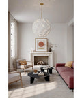 Contemporary Coastal 9 Light Pendant Featuring Legacy Brass Finish And Clean White Ceramic Shades in a modern living room setting.