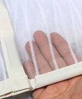 Hand touching white mesh of Upgraded Magnetic Screen Door With 36 Strong Magnets, Heavy Duty Mesh, Hands Free Entry For Pets, Fits Doors Up To 38x82 Inches, White, Quick Close And No Slam With Gravity Sticks.