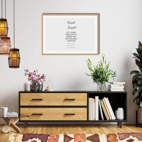 Modern living room with framed art, wooden cabinet, decorative plants, and a colorful rug on wood floor.
