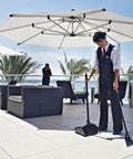 Person using Heavy Duty Dustpan With Long Handle And Pivoting Pan For Easy Debris Dumping In Lobby Restaurant Office And Home Use Black Plastic.