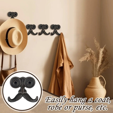 Heckin Durable Four Piece Cast Iron Beard Wall Hooks For Old School Farmhouse Charm and Dang Tough Rustic Decor Hanging Rack for Coats Scarves Towels Keys With Mounting Hardware Included, displayed with a straw hat and a coat.