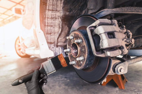Applying Copper Based Anti Seize Lubricant 11 Oz For High Temperature Fasteners Up To 1202 F to car wheel hub with brush
