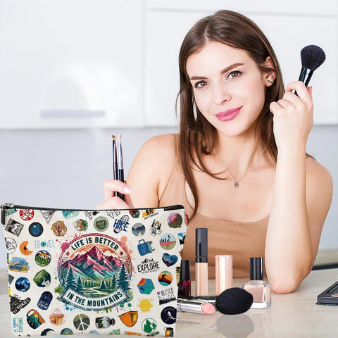 Woman using brushes with "Life is Better in the Mountains" hiking makeup bag, organizer for hikers and campers, toiletry pouch