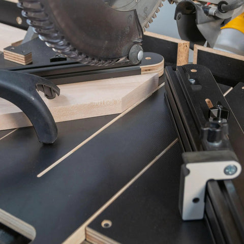 Close-up of Professional Grade Miter Saw Jig delivering dead nuts accurate cuts, featuring solid angle guiding mechanism in use.