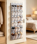 Over The Door Shoe Rack With 28 Spacious Pockets For Max Storage Capacity Breathable Mesh Hanging Shoe Organizer mounted on a door.