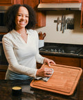Person applying Wood Butter 4 Fl Oz Cutting Board Wax Conditioner For Butcher Block And Wooden Kitchen Tools with cloth on board