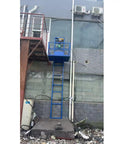 High Capacity Electric Lift Table Glides Smooth As Butter, Crushes Over Four Hundred Kilograms Like A Champ positioned outside a building.