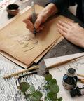 Old School Vintage Letter Paper Pack With 60 Sheets used for calligraphy with ink, brushes, and design tools on table