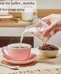 Borosilicate Glass Measuring Cup 1 Cup 8oz with Spout pouring milk into coffee with clear readouts visible