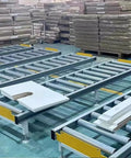 Super Heavy Duty Modular Conveyor Rollers And Connectable Discharge Chutes With Smooth Metal Roller Slide Kit For No Sweat Warehouse Dumping And Quick Truck Bed Unloading Rock Solid 5 Piece Pack Silver in a busy warehouse setting.
