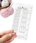 Quick Gauge Ruler For Knitting And Crochet No Sweat Stitch Measurement Tool With Clear Grid Layout held next to yarn and needles.