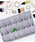 Lowkey Perfect Multi Grid Jewelry Tray For Rings And Necklaces With Smart Dividers To Keep Your Daily Treasures Sorted And Secure While Adding Those Chill Vibes To Any Vanity Or Desk Corner Setup. Gray tray with organized compartments for rings.