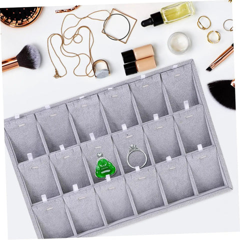 Lowkey Perfect Multi Grid Jewelry Tray For Rings And Necklaces With Smart Dividers To Keep Your Daily Treasures Sorted And Secure While Adding Those Chill Vibes To Any Vanity Or Desk Corner Setup. Gray tray with organized compartments for rings.