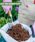 Person holding Beefy Stainless Steel Bend Proof Garden Trowel With Comfortable Wood Handle, scooping soil from compost bag.