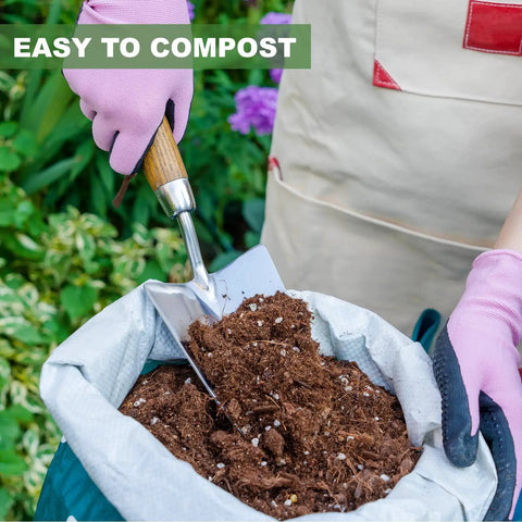 Person holding Beefy Stainless Steel Bend Proof Garden Trowel With Comfortable Wood Handle, scooping soil from compost bag.