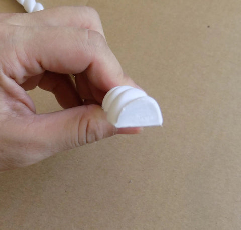 Close-up of Flexible Door Molding Trim Rope Edge Wall And Cabinet Dope 0.6in X 115in showing white PVC material and rope-like profile