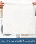 White microfiber cleaning cloth held by hands, 11.8 x 11.8 inches; machine washable and reusable.