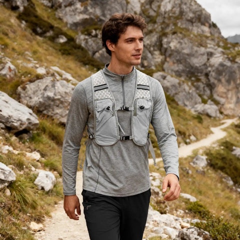 Man hiking wearing Ultralight Running Vest With Breathable Quick Dry Mesh Chest Pack Hydration Ready Kit For Runners And Outdoorsy Folks Adjustable Straps Waterproof Phone Pocket Great For Hiking Cycling Camping And Climbing.